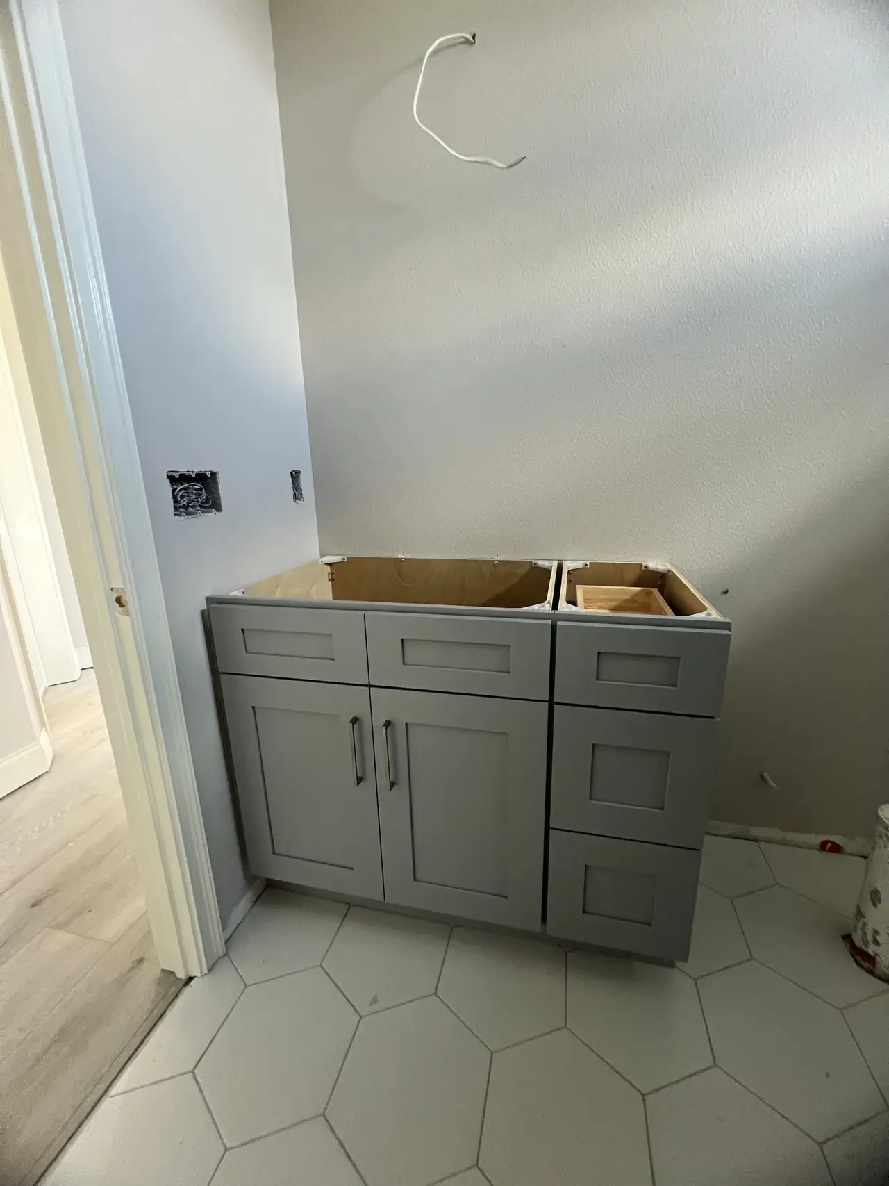 Sage-gray shaker drawer bases set and leveled in a Tampa Bay home