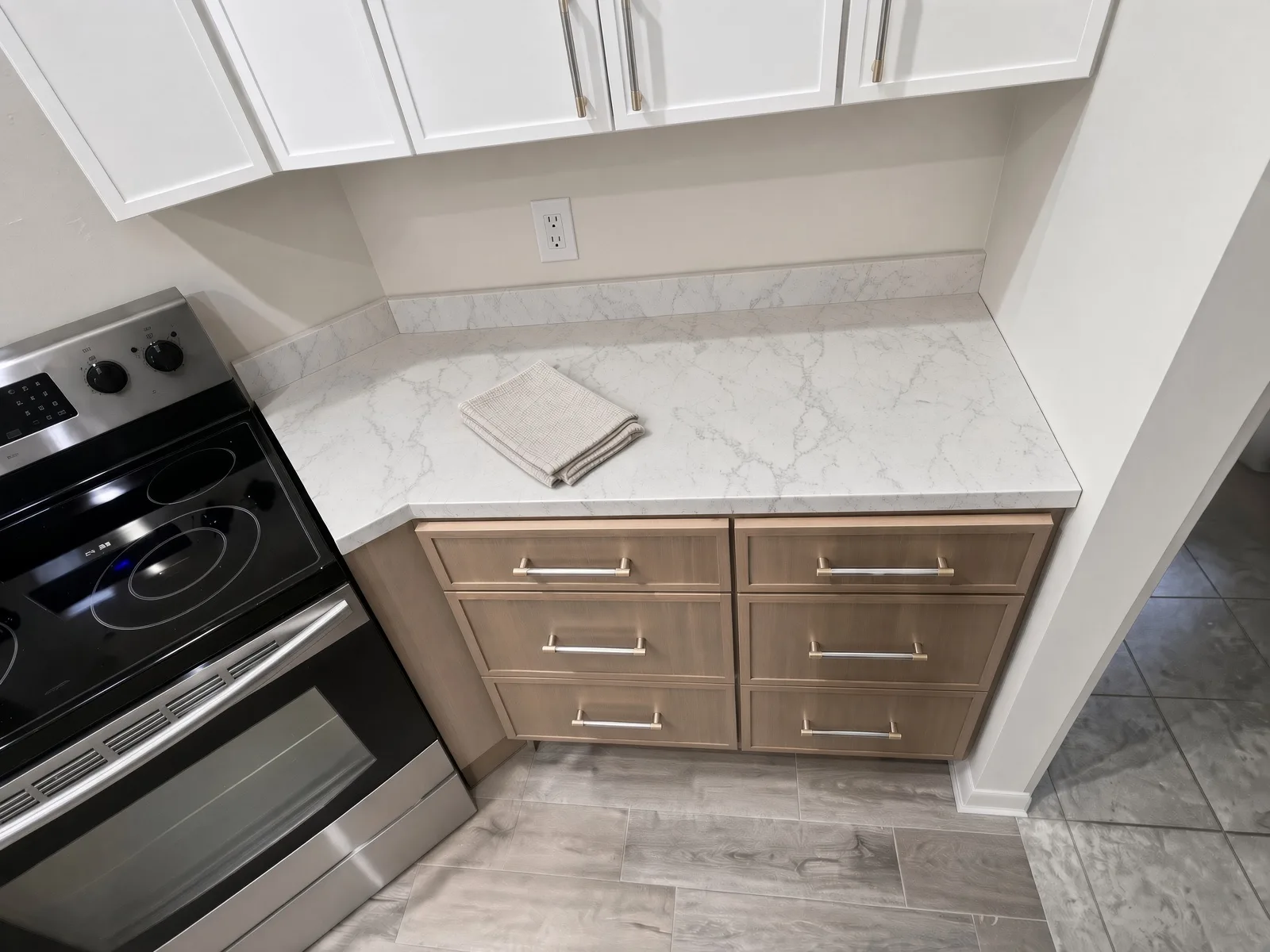 Natural wood cabinet drawers with soft-close in a two-tone Tampa kitchen