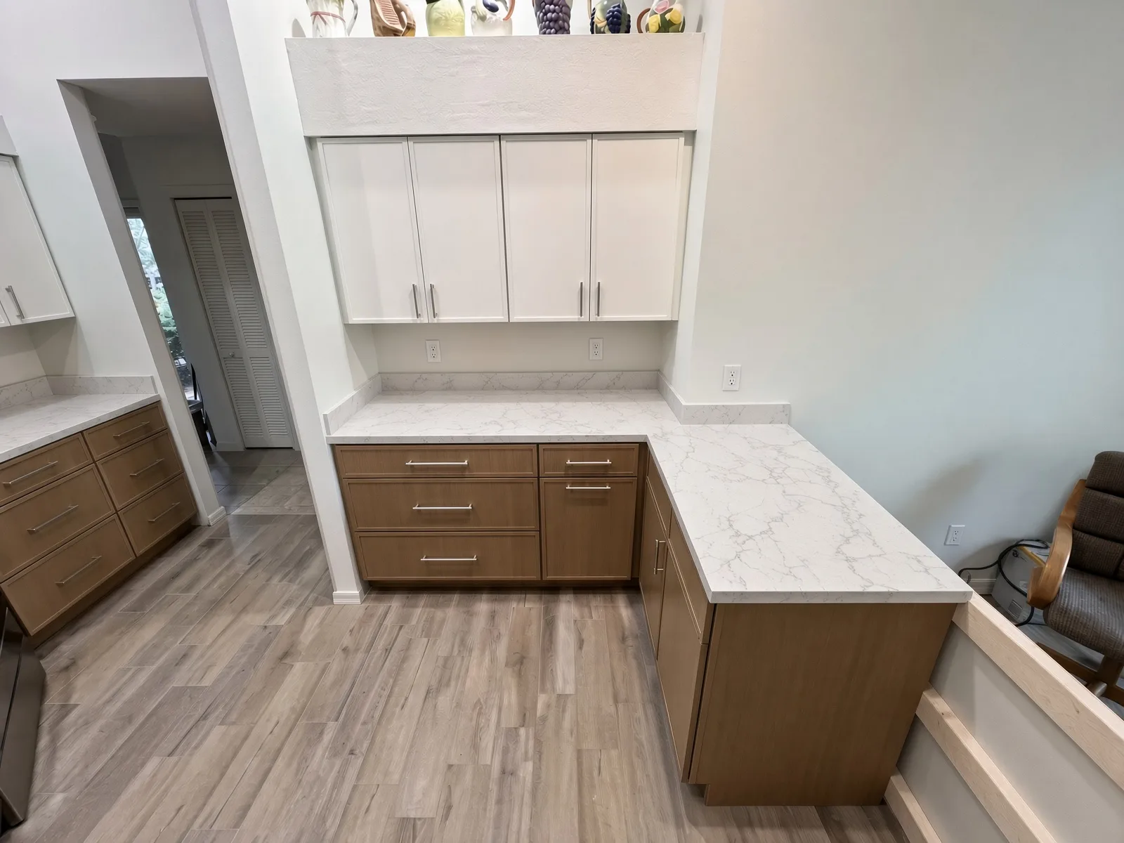 Two-tone Tampa kitchen with white uppers and natural wood island cabinets