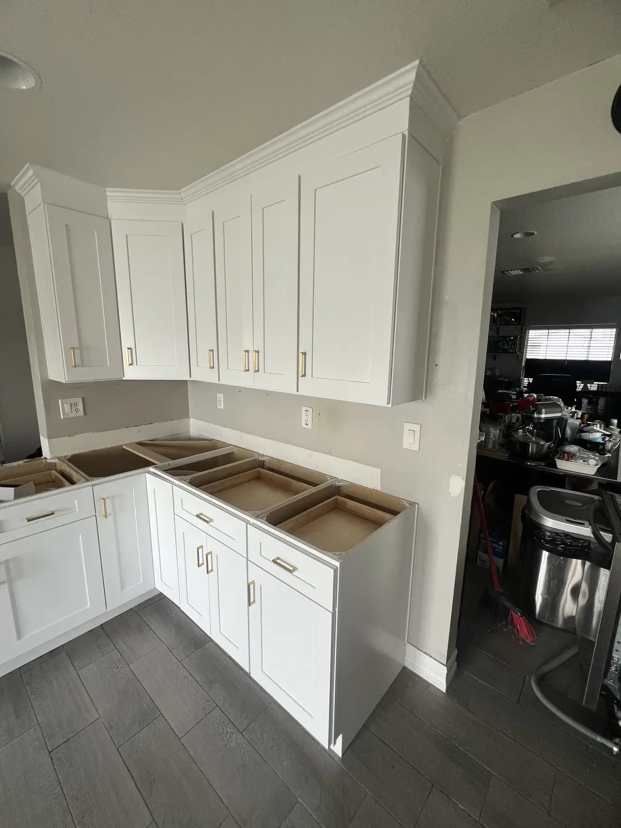 White corner kitchen cabinets with a warm wood accent in Tampa