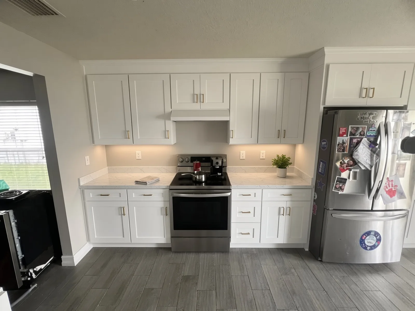 Bright white kitchen cabinets with stainless refrigerator in Tampa