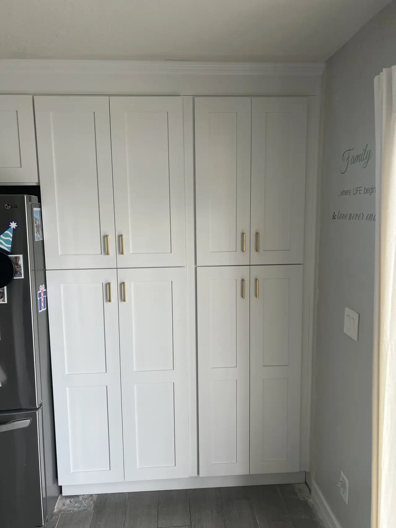Floor-to-ceiling white pantry cabinets in a Tampa kitchen